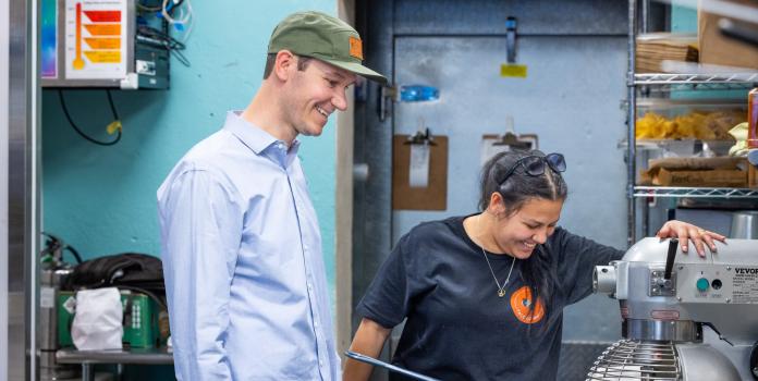 Matias Gutneckt in the kitchen of his restaurant, Taco Uprising, with an employee