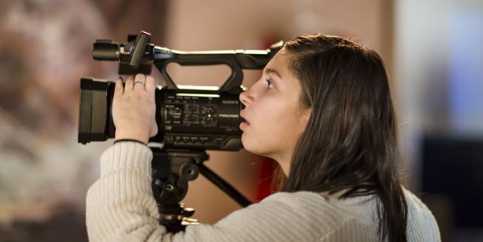 Student adjusts video equipment during Colorado High School Film Festival