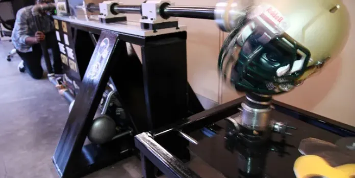 Student testing helmet on a machine in the CU Denver Outdoor Lab