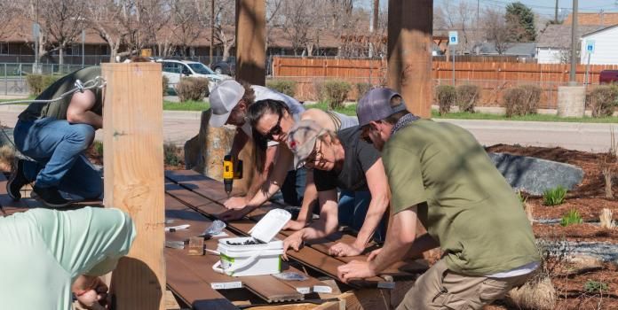 A group of people build playground structure