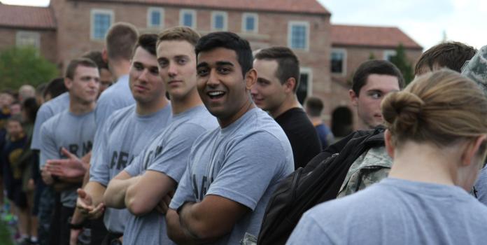 a group of men and women prepare to train for military exercises