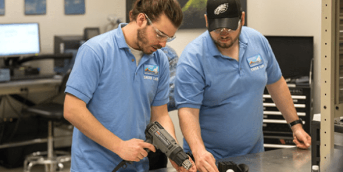 Two doctoral students inspect new material