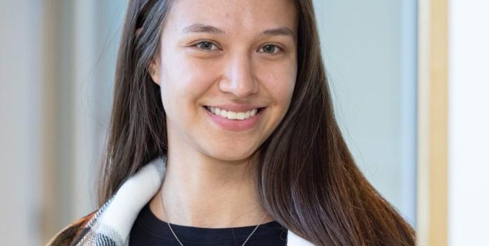 A young woman smiles for a portrait