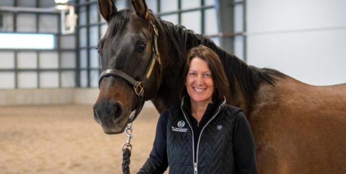 Co-Principal Investigator Laurie Goodrich, DVM PhD, a veterinary clinician scientist and director of the Orthopaedic Research Center at Colorado State University’s Translational Medicine Institute stands next to a horse