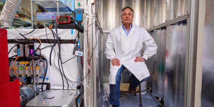 Mark Hernandez sitting in a lab with air testing equipment