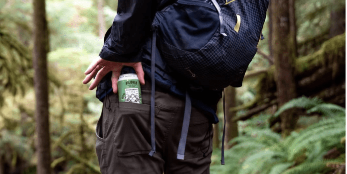 A hiker packs a can of Holidaily Beer in their back pocket