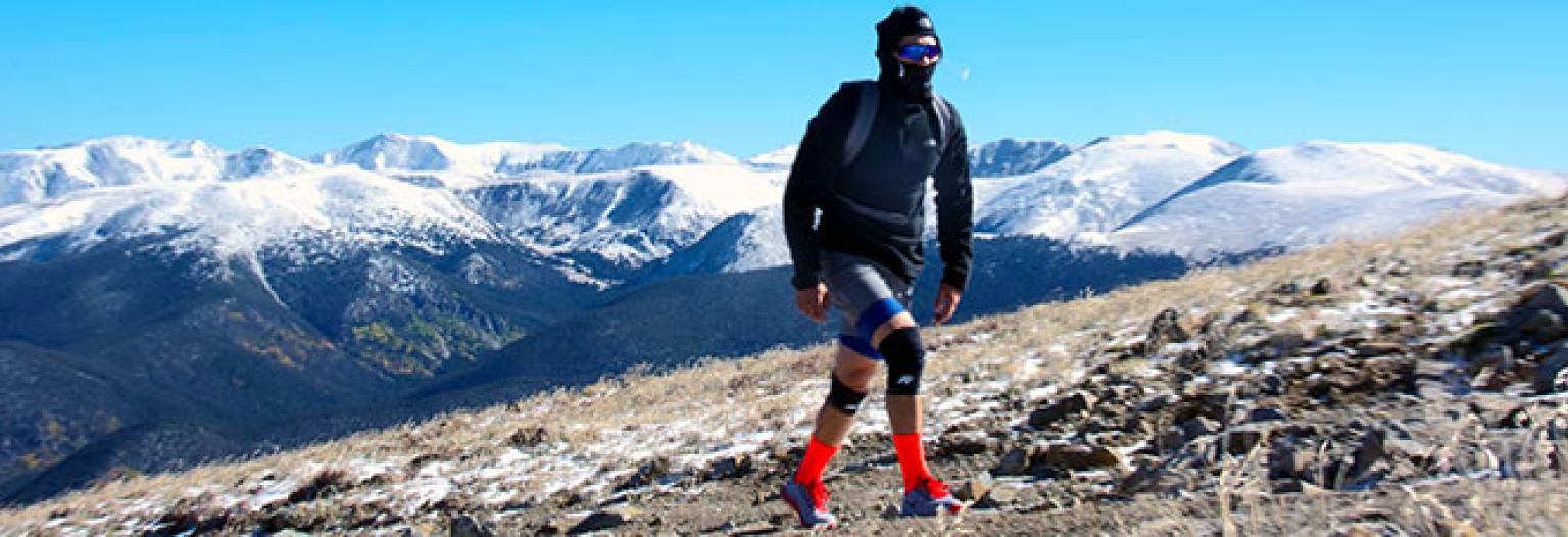 Man climbing mountain in outdoor gear