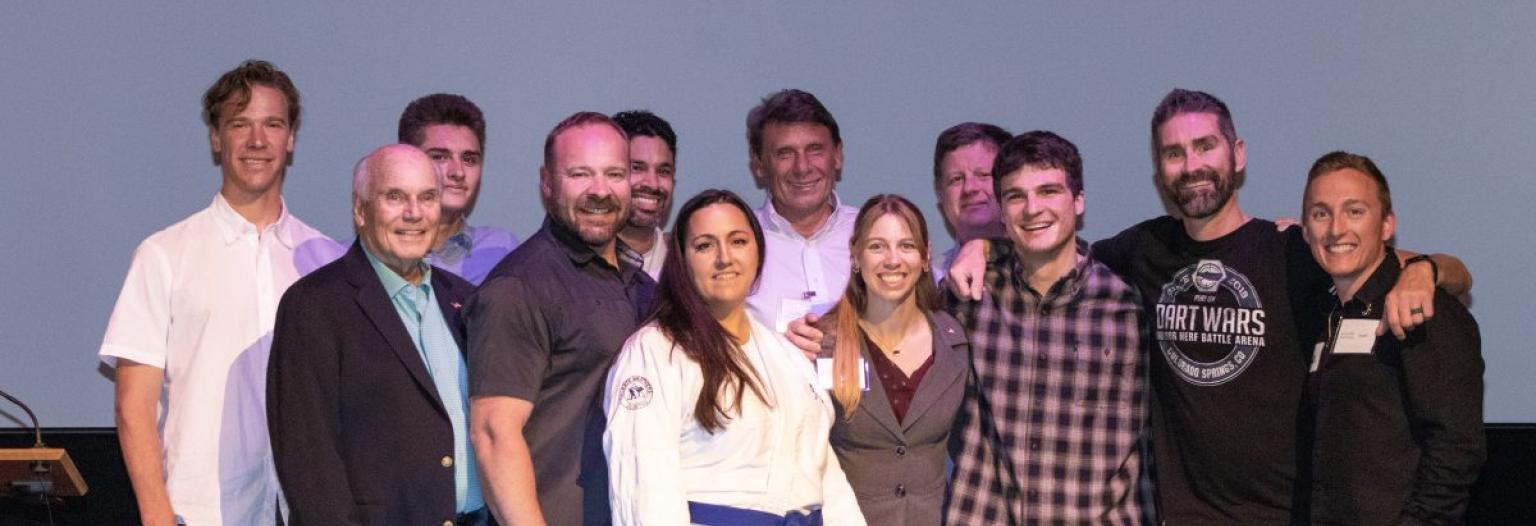 A group of people poses on stage