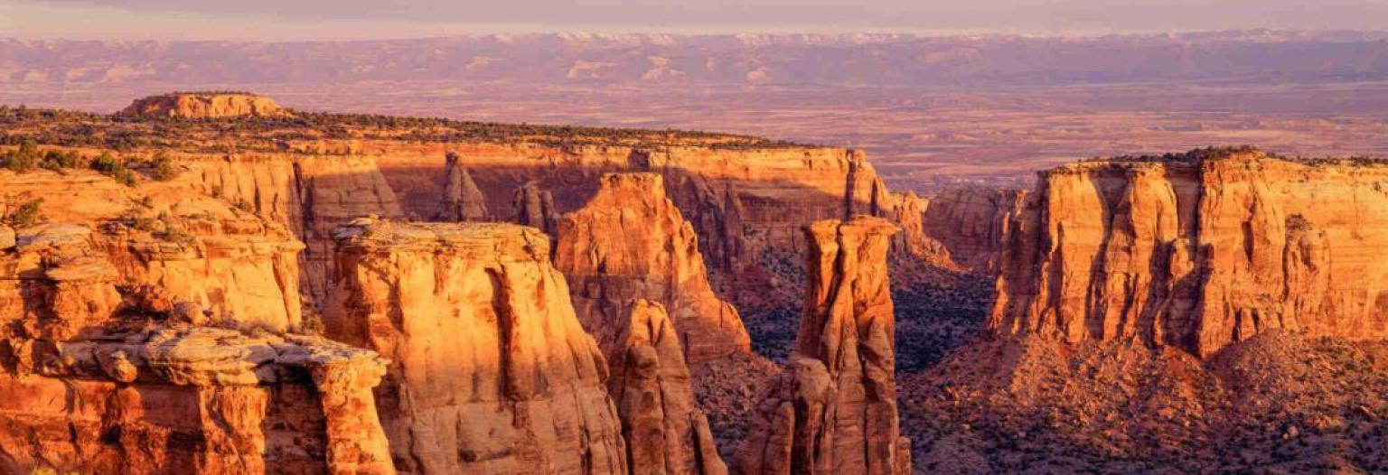 The sun setting over a rock canyon