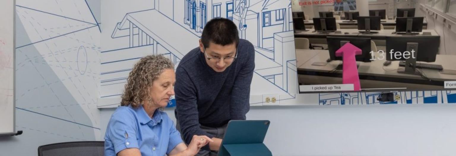 Two people looking at an iPad