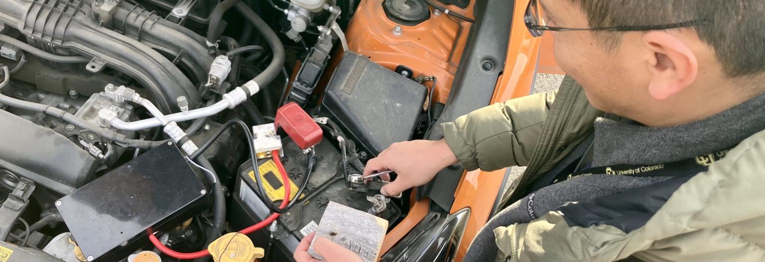 Professor Liang He overhead view of car engine and anti-theft tech