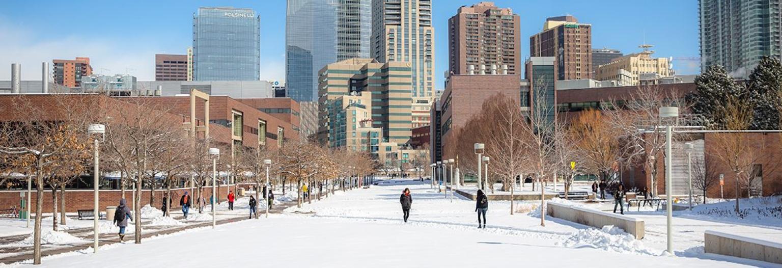 People walk across CU Denver's snowy campus