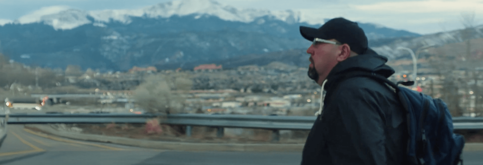 Profile of a man with mountains in the background