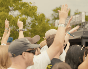 crowd of people dance at concert